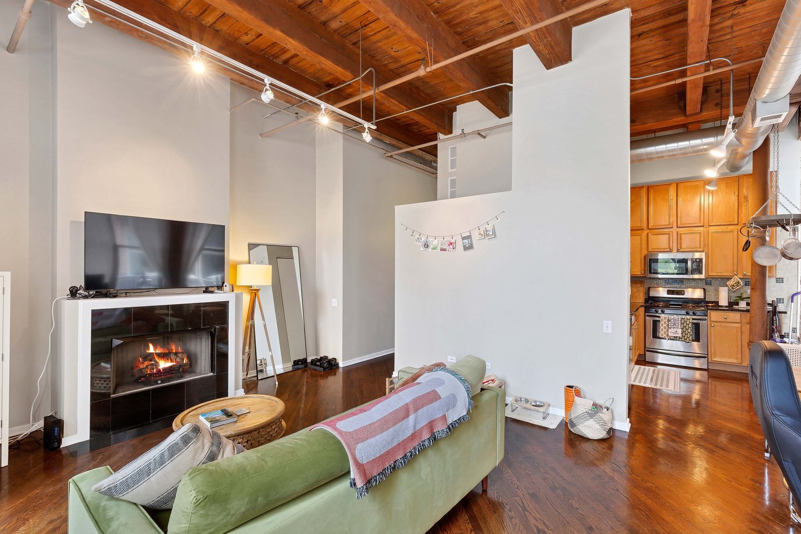 550 West Harrison Street, Unit 353 Chicago, IL 60607 - Photo 4 of 16 a living room with furniture and a fireplace