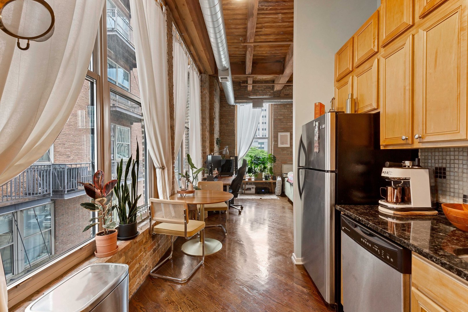 550 West Harrison Street, Unit 353 Chicago, IL 60607 - Photo 6 of 16 a kitchen with stainless steel appliances a refrigerator a stove a sink and cabinets