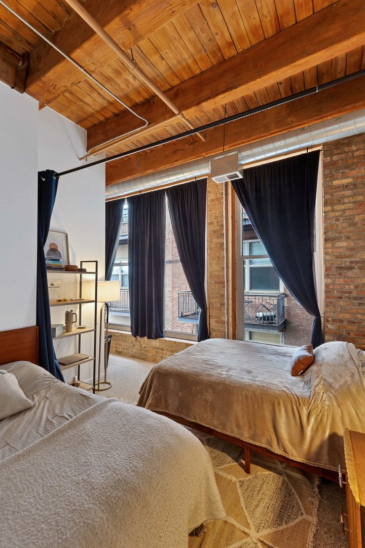 550 West Harrison Street, Unit 353 Chicago, IL 60607 - Photo 9 of 16 a bedroom with a bed and a closet