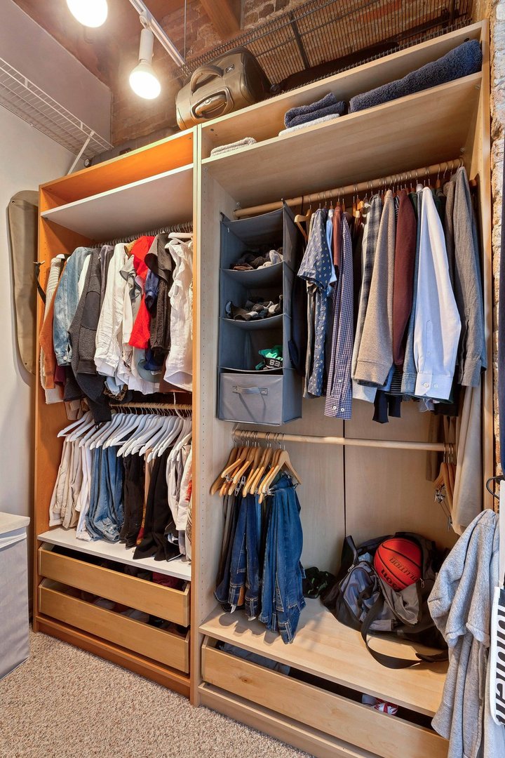 550 West Harrison Street, Unit 353 Chicago, IL 60607 - Photo 10 of 16 a view of walk in closet with clothes and shoes