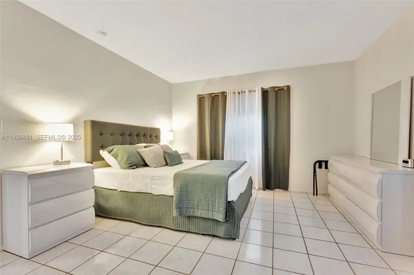 a bedroom with a bed and a view of walk in closet