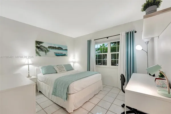 a bedroom with a bed and a table