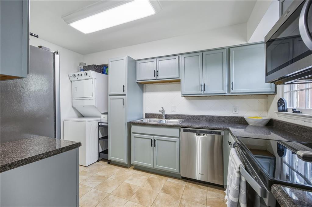 2763 Farmstead Road Smyrna, GA 30080 - Photo 18 of 35 a kitchen with stainless steel appliances granite countertop a refrigerator a stove and a sink