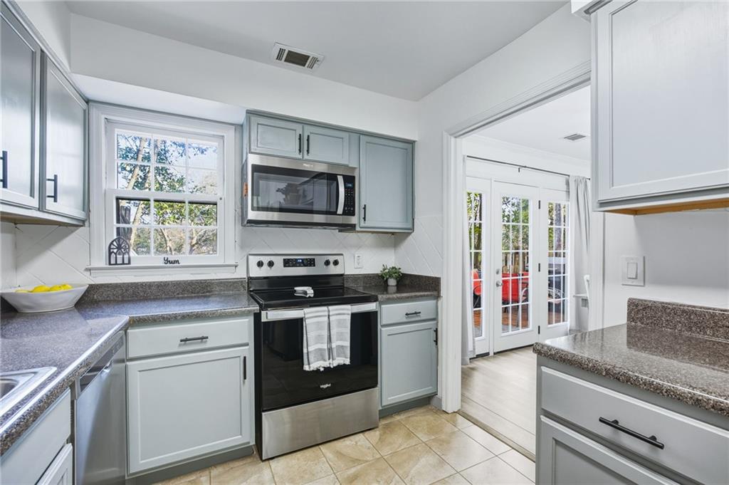 2763 Farmstead Road Smyrna, GA 30080 - Photo 20 of 35 a kitchen with stainless steel appliances granite countertop a stove and a sink