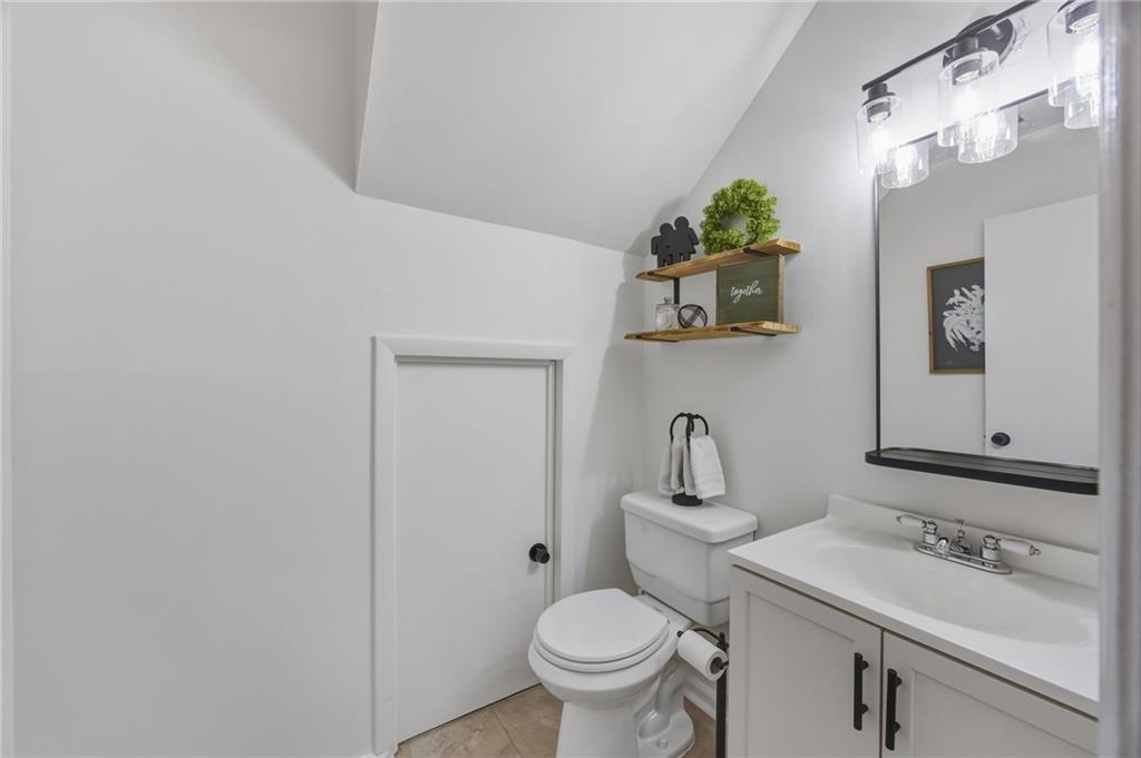 2763 Farmstead Road Smyrna, GA 30080 - Photo 21 of 35 a bathroom with a toilet sink and mirror