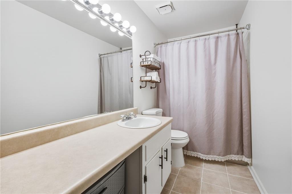 2763 Farmstead Road Smyrna, GA 30080 - Photo 25 of 35 a bathroom with a sink a toilet and shower curtain