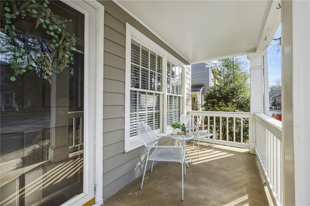 2763 Farmstead Road Smyrna, GA 30080 - Photo 5 of 35 a porch with a bench next to a yard