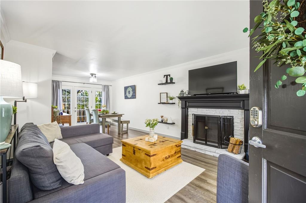 2763 Farmstead Road Smyrna, GA 30080 - Photo 6 of 35 a living room with furniture a flat screen tv and a fireplace