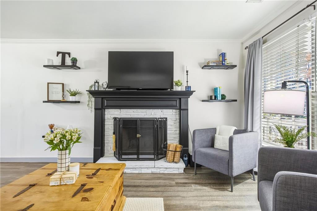2763 Farmstead Road Smyrna, GA 30080 - Photo 8 of 35 a living room with furniture a flat screen tv and a fireplace