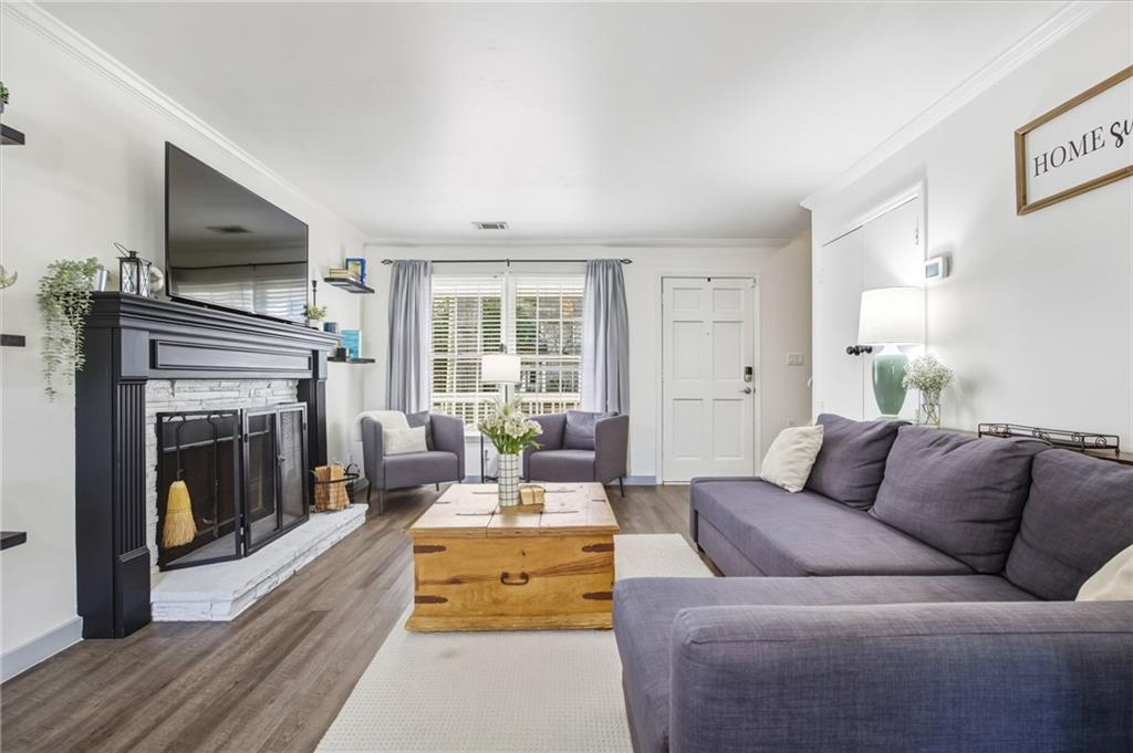 2763 Farmstead Road Smyrna, GA 30080 - Photo 9 of 35 a living room with furniture and a fireplace