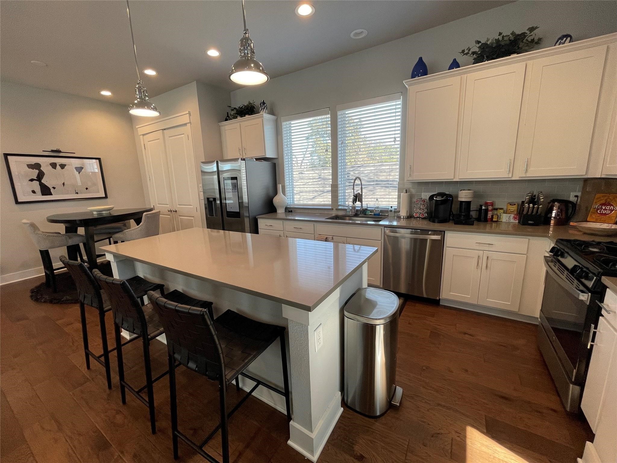 902 Martin Street, Unit A Houston, TX 77018 - Photo 4 of 21 a kitchen with a table chairs refrigerator and microwave