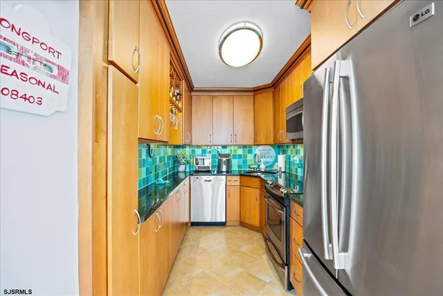 a kitchen with stainless steel appliances granite countertop a stove and a refrigerator
