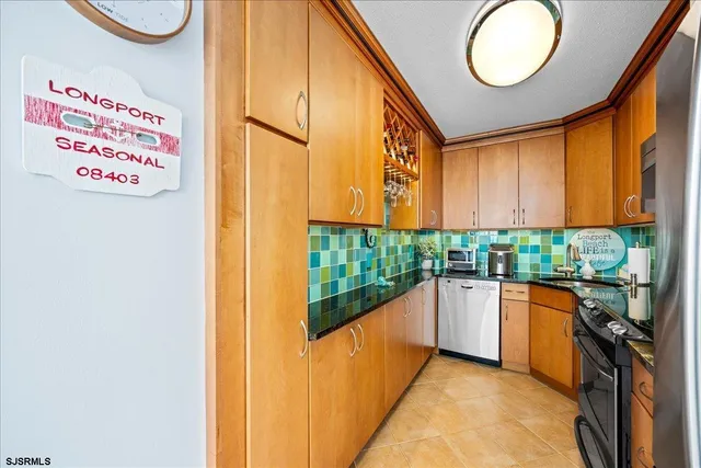a kitchen with stainless steel appliances granite countertop a stove and a microwave