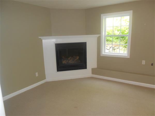 6 Longfellow Road, Unit B Groton, MA 01450 - Photo 9 of 11 an empty room with windows and fireplace