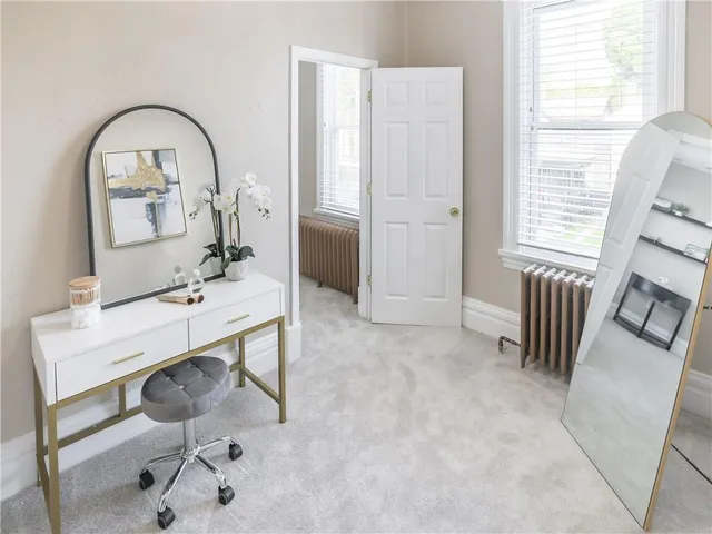 a bedroom with a bed chair and window