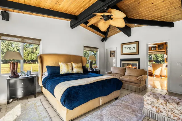 a bedroom with a bed and a large window