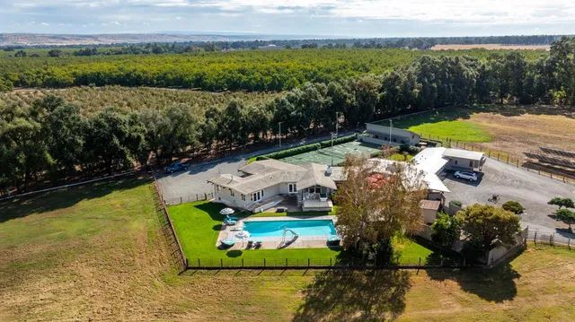 a view of a swimming pool with a yard