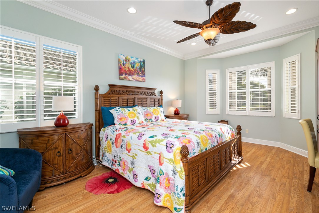 9055 Springview Loop Estero, FL 33928 - Photo 17 of 35 a bedroom with a bed and wooden floor