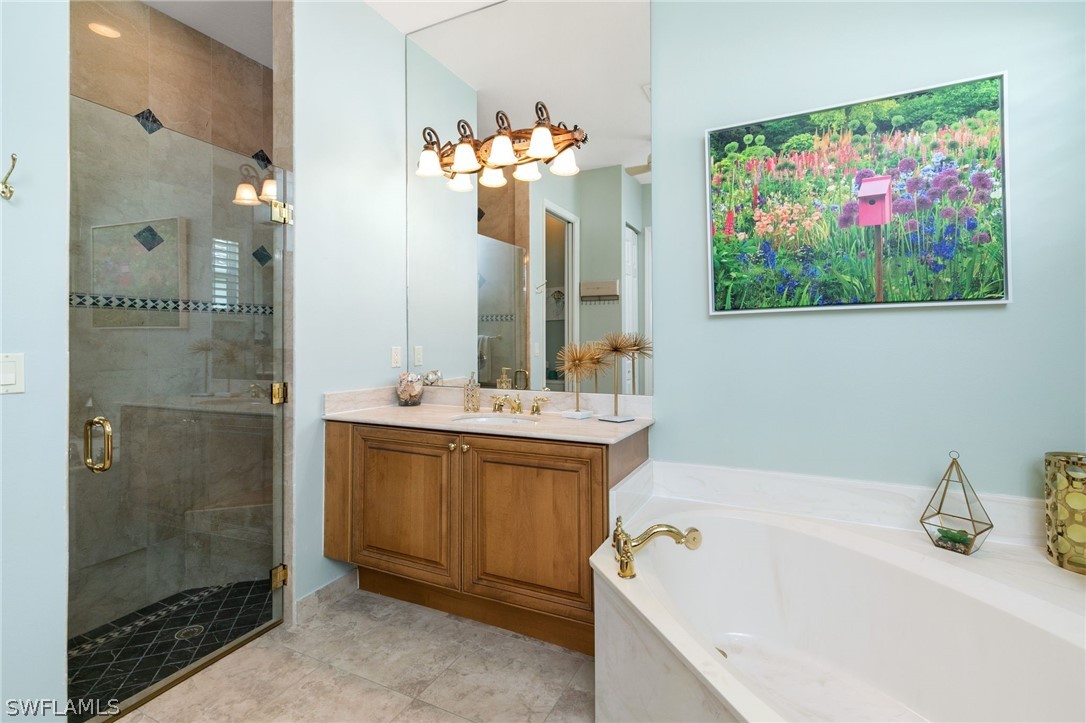 9055 Springview Loop Estero, FL 33928 - Photo 19 of 35 a bathroom with a tub sink and mirror