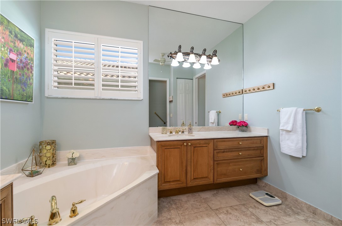 9055 Springview Loop Estero, FL 33928 - Photo 20 of 35 a bathroom with a tub sink and mirror