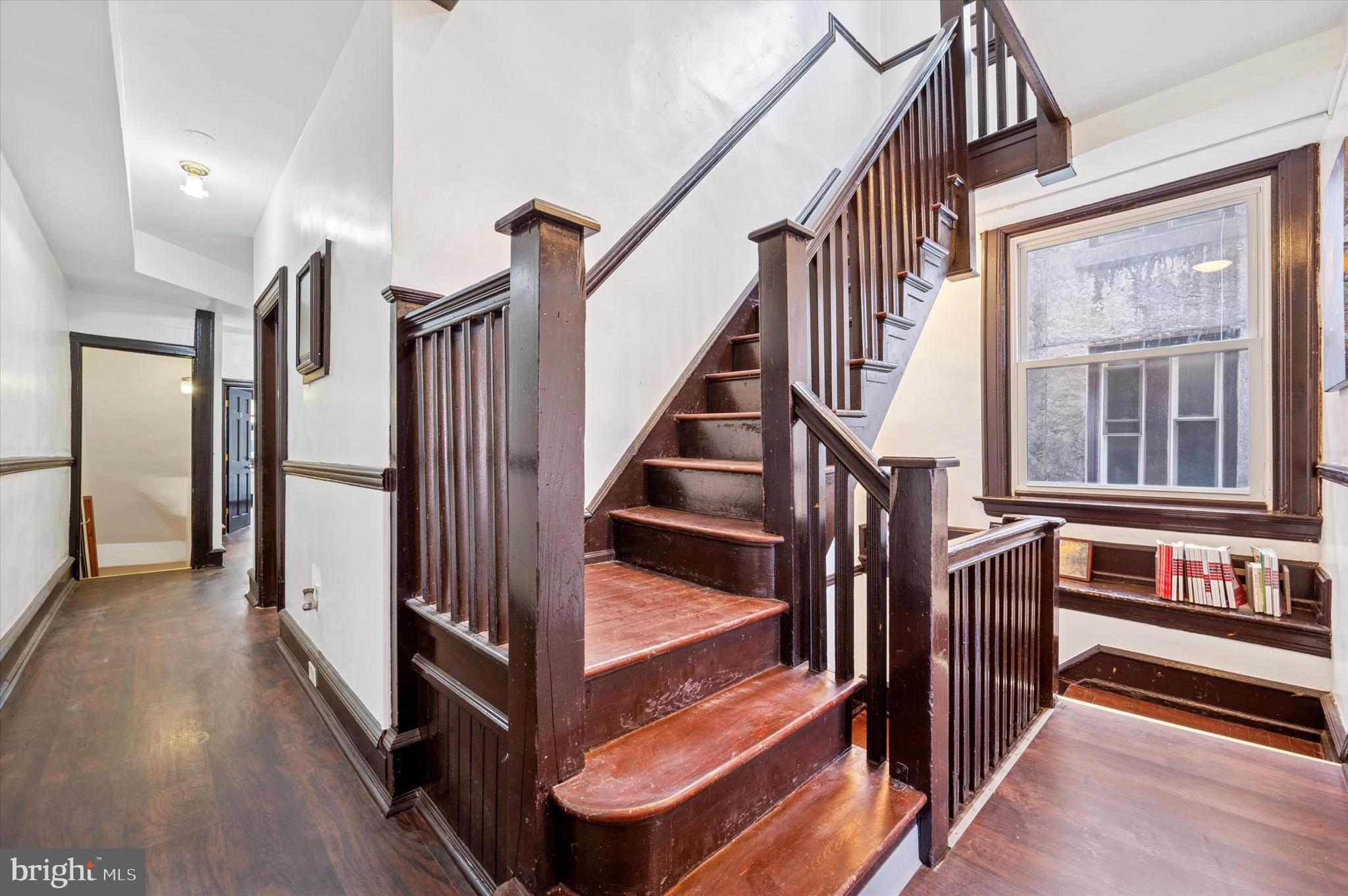 4518 Walnut Street Philadelphia, PA 19139 - Photo 12 of 36 a view of staircase with lots of frames on wall and a window