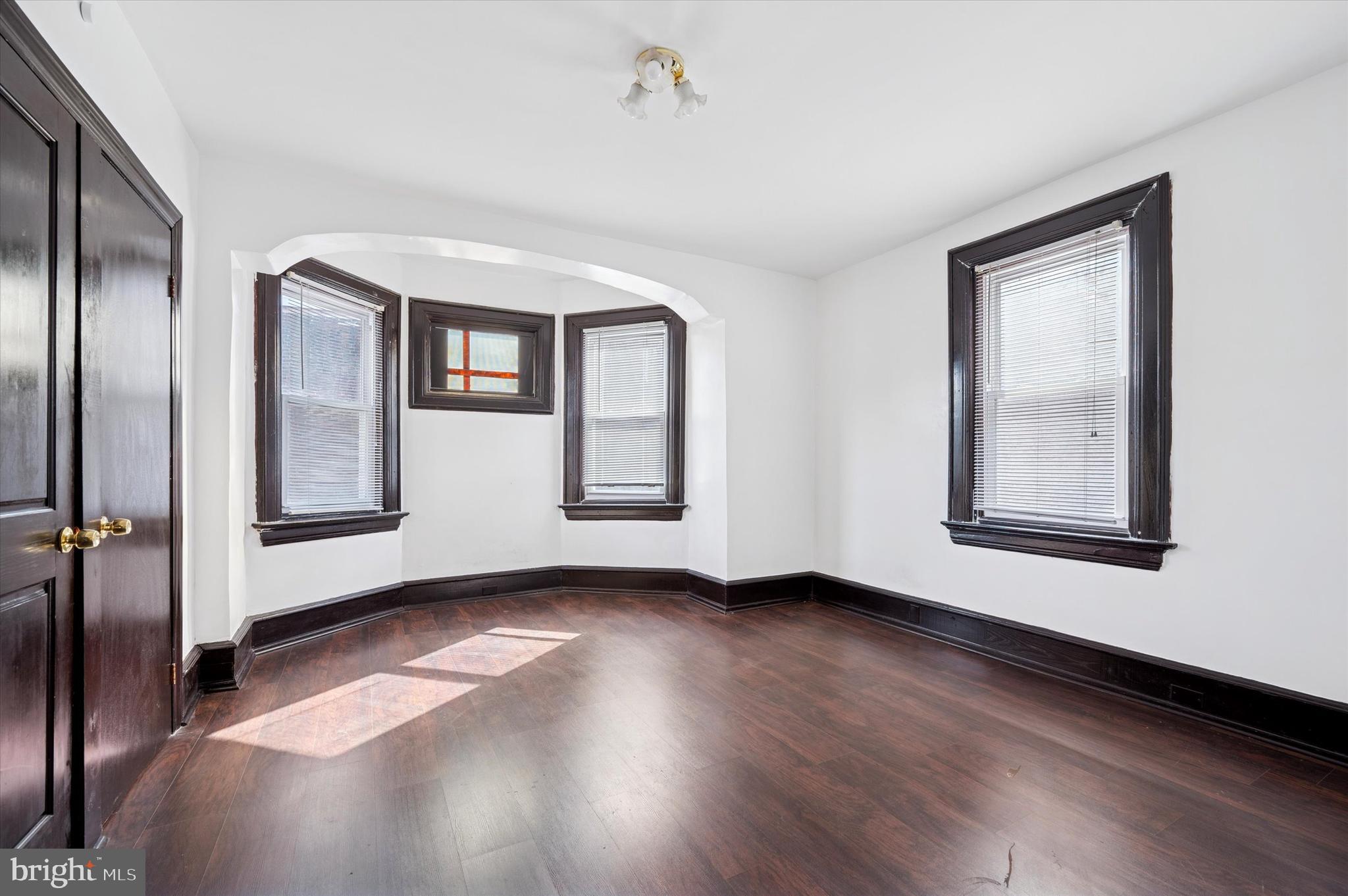 4518 Walnut Street Philadelphia, PA 19139 - Photo 16 of 36 a view of an empty room with wooden floor and a window