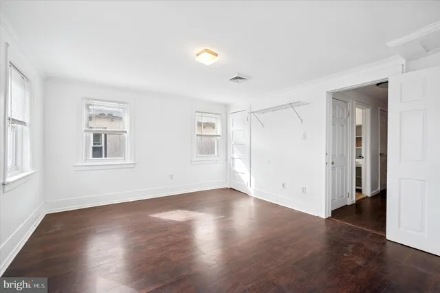 a view of a house with a small yard and flower plants