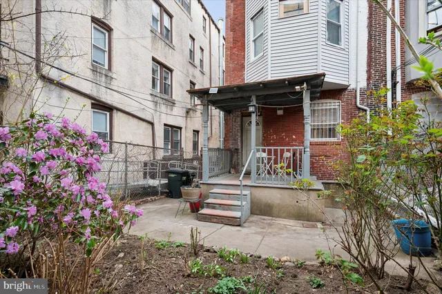 a view of patio with a table and chairs and potted plants