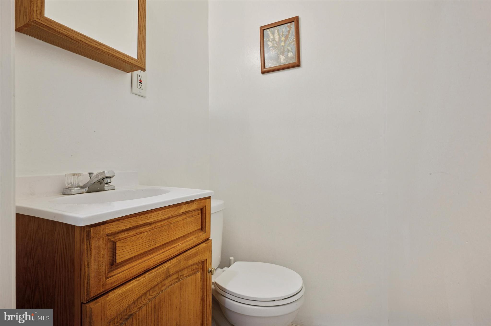 4518 Walnut Street Philadelphia, PA 19139 - Photo 9 of 36 a bathroom with a sink a toilet and mirror
