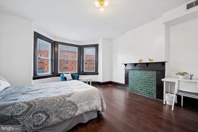 a spacious bedroom with a bed and a window