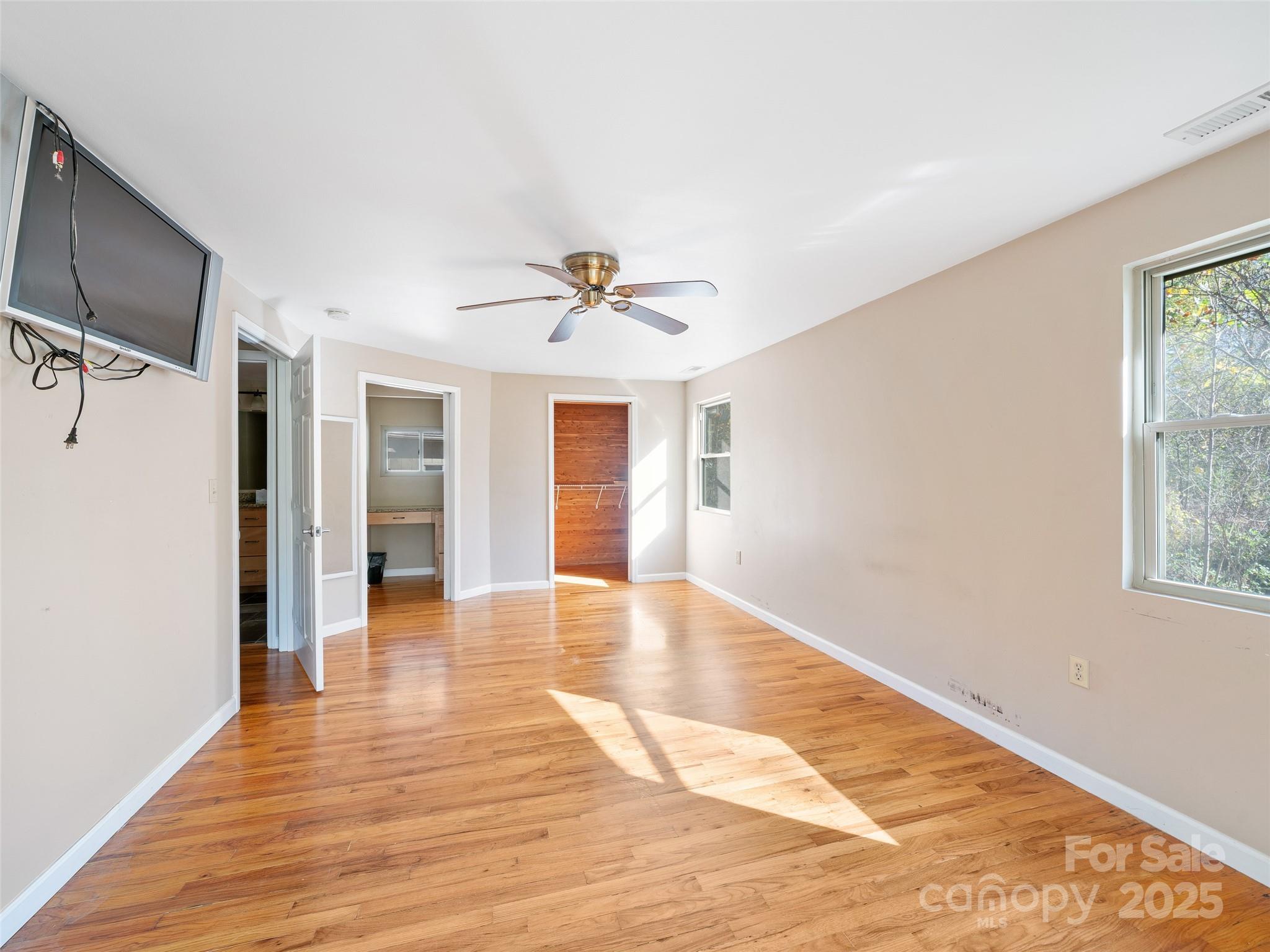 19 Old Patton Hill Road Swannanoa, NC 28778 - Photo 13 of 44 a view of a livingroom with wooden floor and a ceiling fan