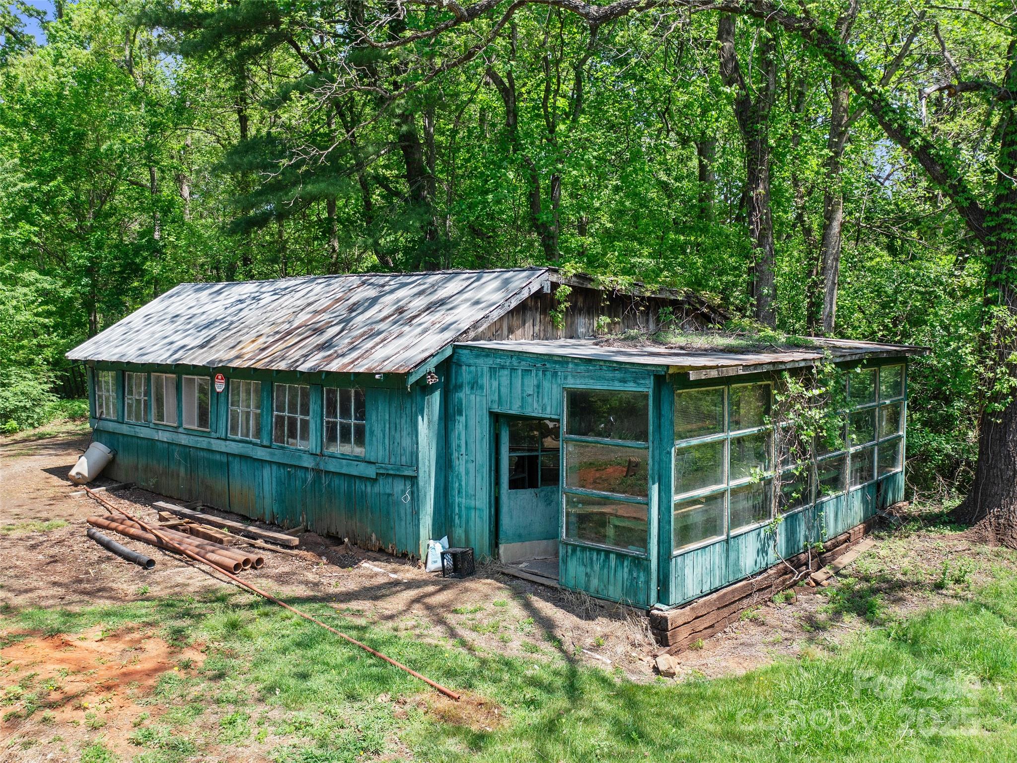 19 Old Patton Hill Road Swannanoa, NC 28778 - Photo 23 of 44 a view of a wooden house with a small yard and large trees