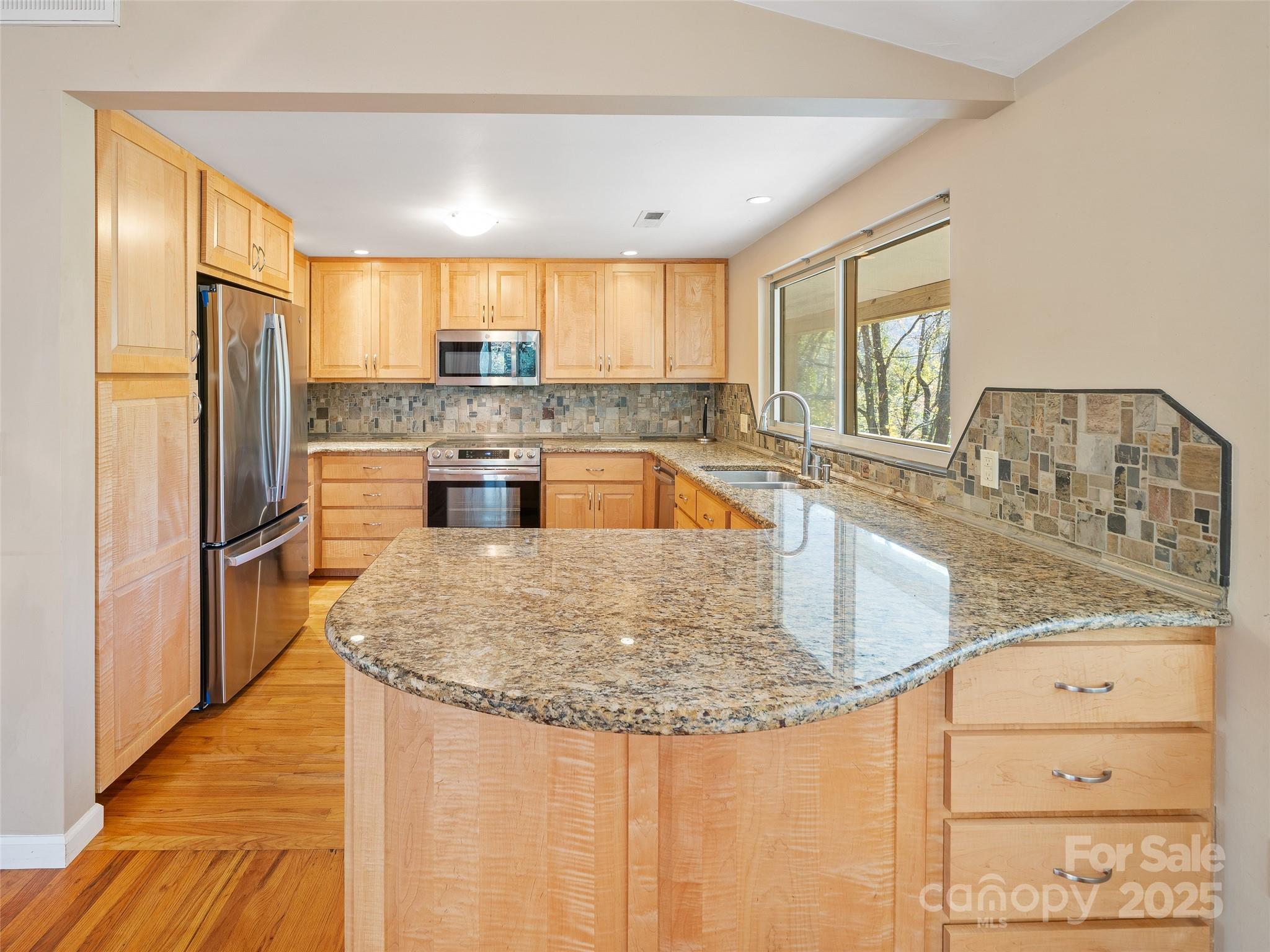 19 Old Patton Hill Road Swannanoa, NC 28778 - Photo 8 of 44 a kitchen with stainless steel appliances granite countertop a sink stove and refrigerator