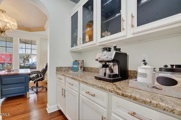 a kitchen with kitchen island granite countertop stainless steel appliances and refrigerator