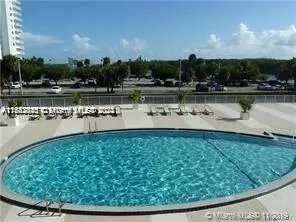 a view of a swimming pool and trees in the background