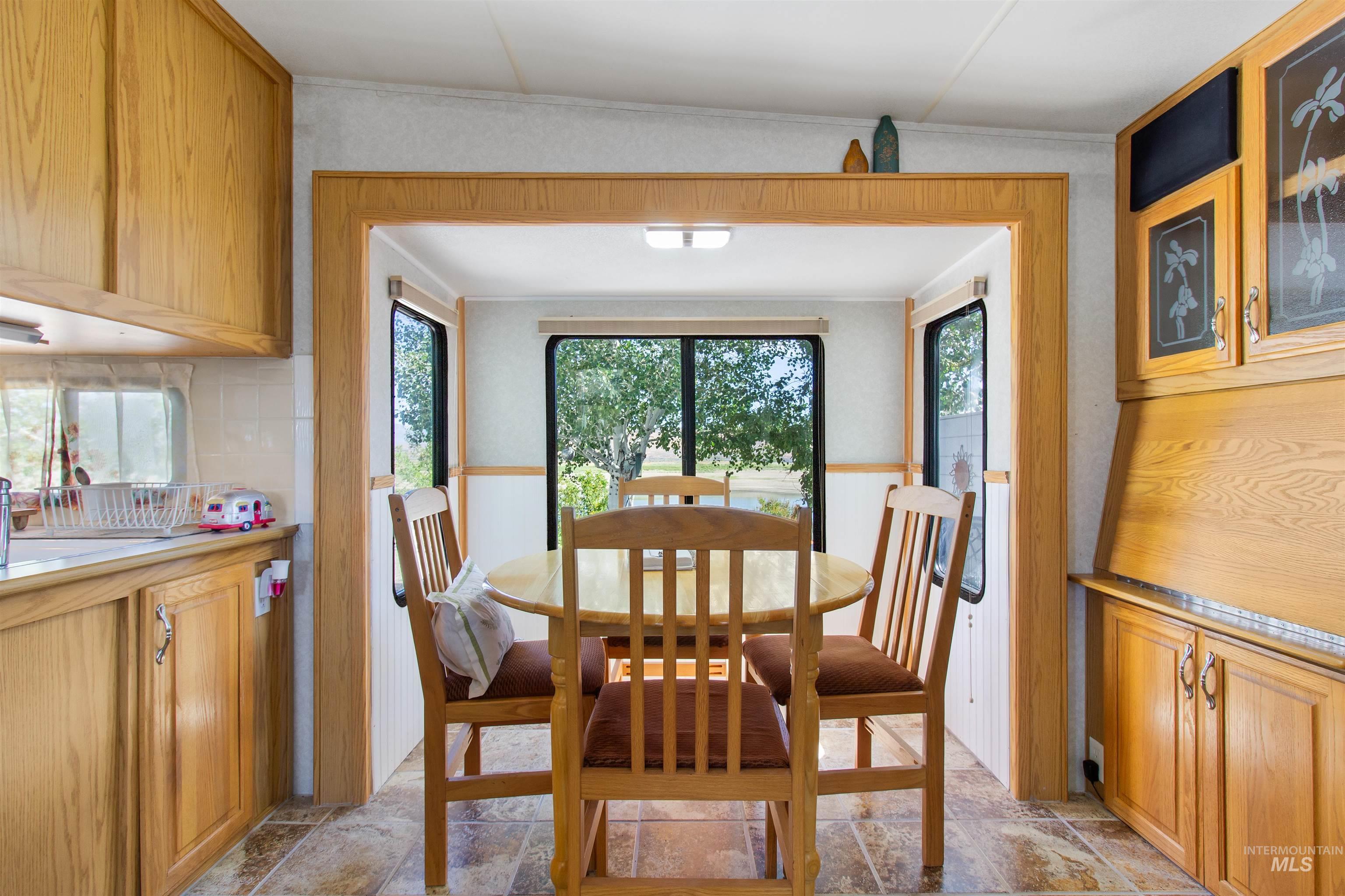 106 West Magic Road Shoshone, ID 83352 - Photo 15 of 45 Dining area featuring a wood-finish table with seating, bordered by an entryway with wood-finish trim