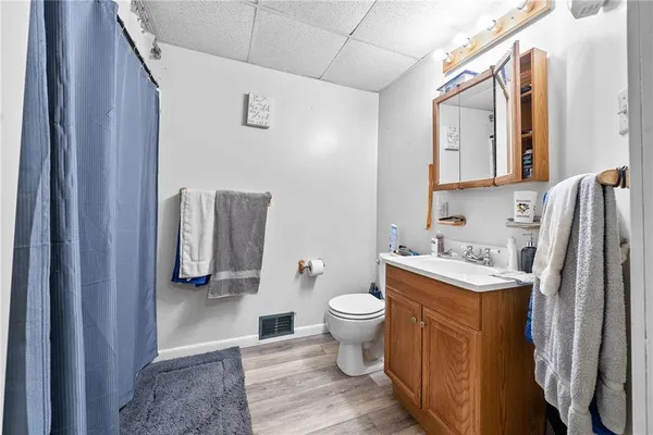 a bathroom with a toilet sink and mirror
