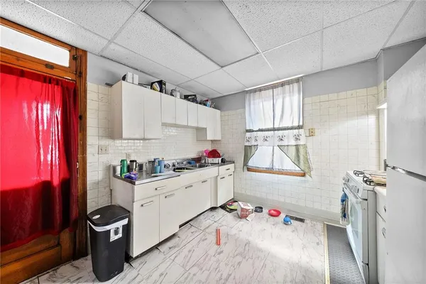 a kitchen with a sink appliances and cabinets