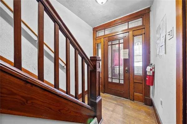 a view of staircase with railing and a large window