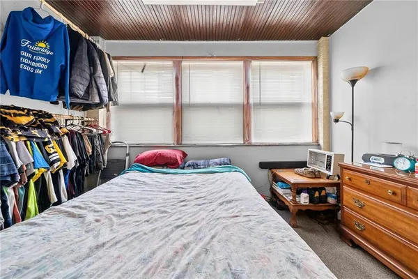 a bedroom with bed and a window
