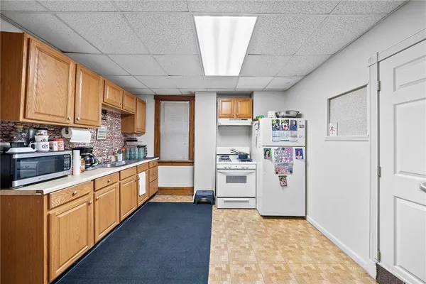a kitchen with stainless steel appliances a refrigerator and cabinets