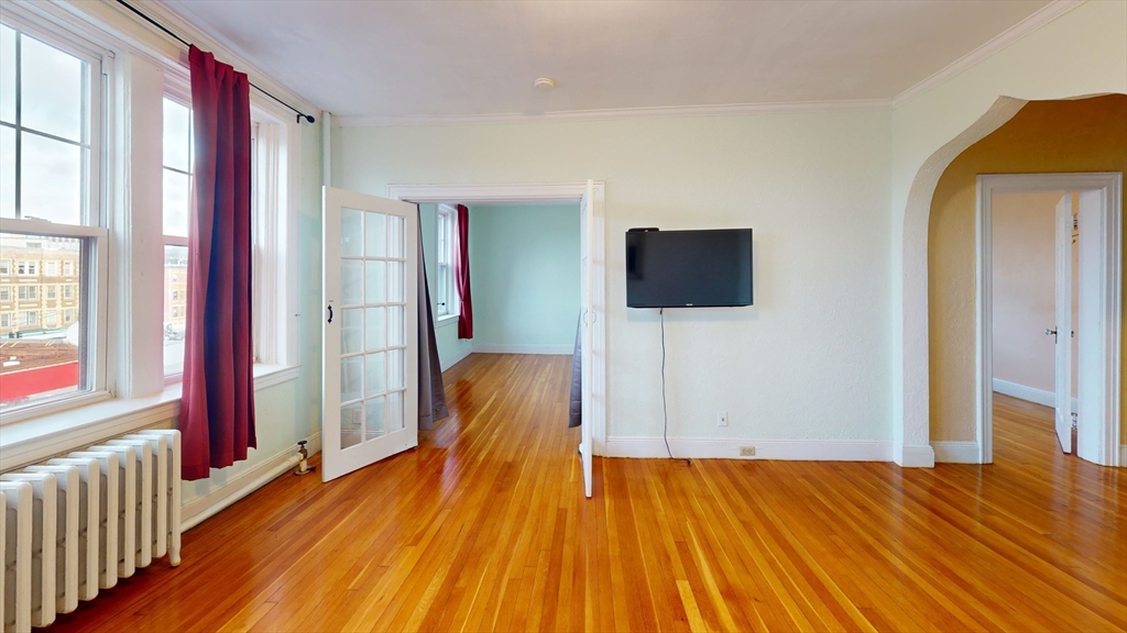 10 Jamaicaway, Unit 24 Boston, MA 02130 - Photo 2 of 9 a view of a livingroom with wooden floor and flat screen tv