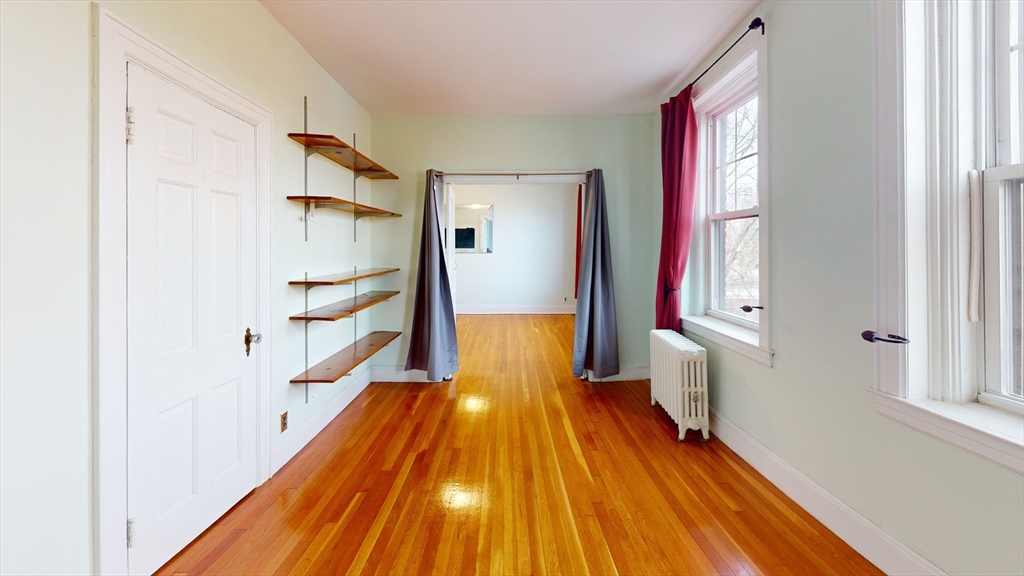 10 Jamaicaway, Unit 24 Boston, MA 02130 - Photo 5 of 9 a view of a bathroom with wooden floor and staircase