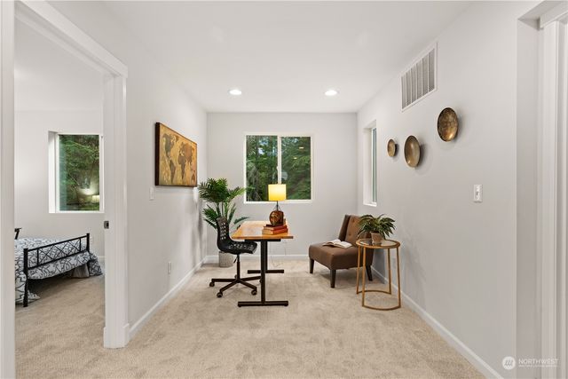 a view of a livingroom with workspace and a window