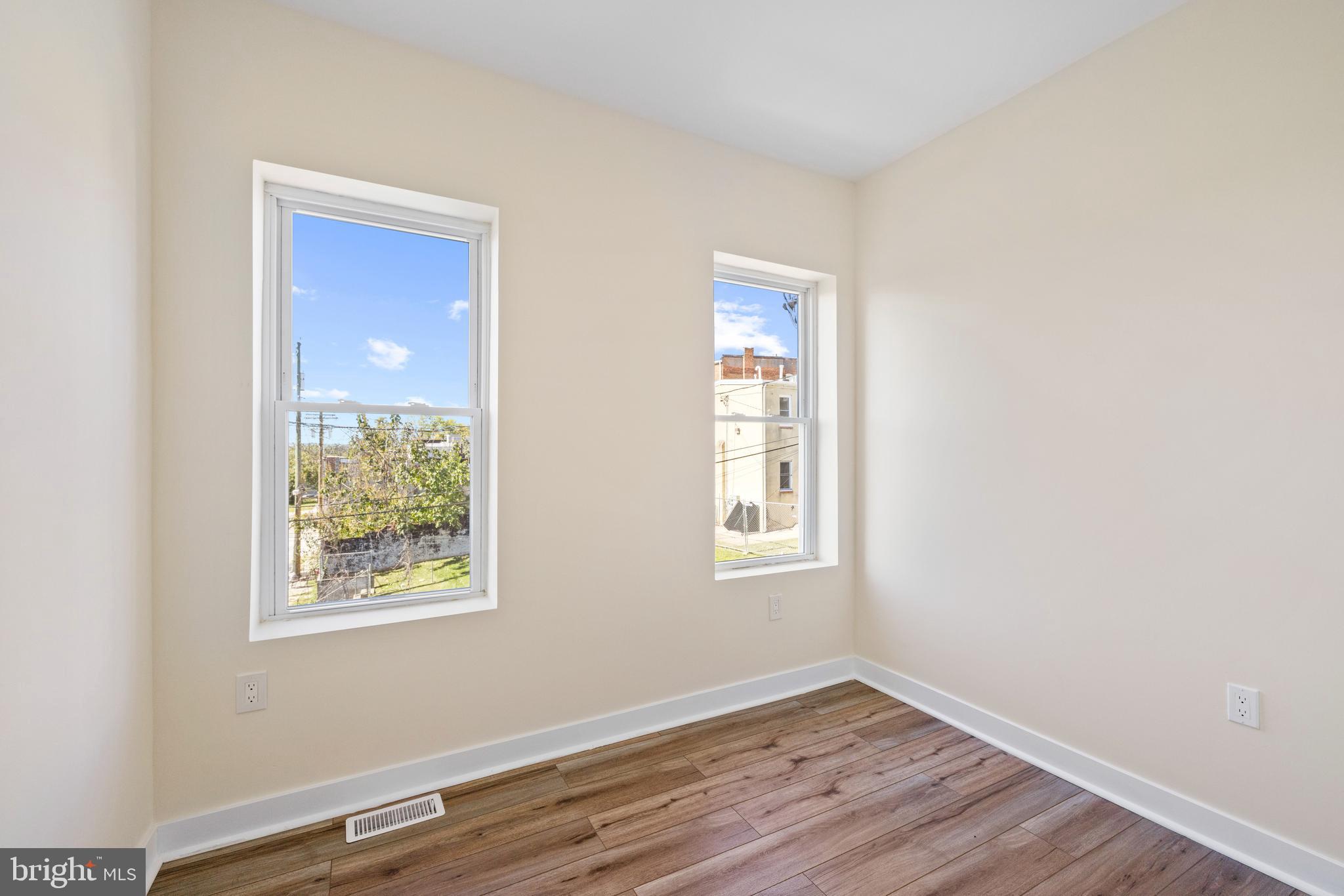 6 South Payson Street Baltimore, MD 21223 - Photo 13 of 17 a view of an empty room with wooden floor and a window