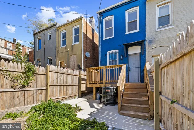 a view of a house with wooden fence