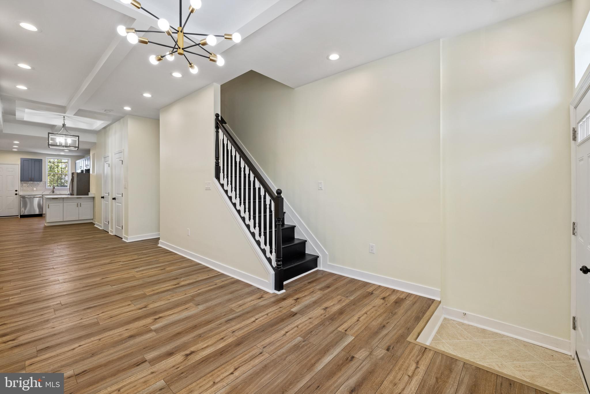 6 South Payson Street Baltimore, MD 21223 - Photo 2 of 17 a view of an empty room with wooden floor and a ceiling fan