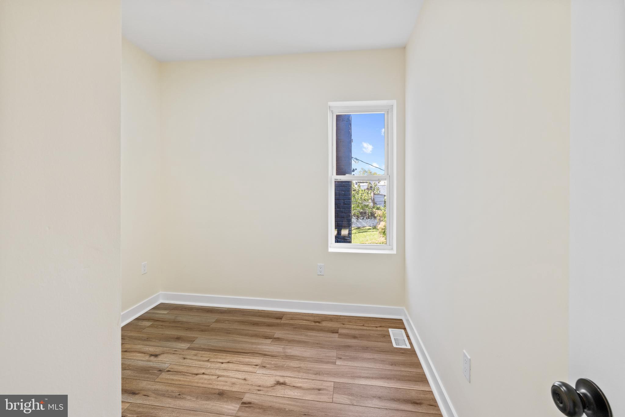 6 South Payson Street Baltimore, MD 21223 - Photo 7 of 17 a view of an empty room with wooden floor and a window