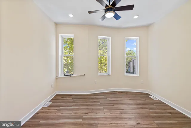 wooden floor in an empty room with a window