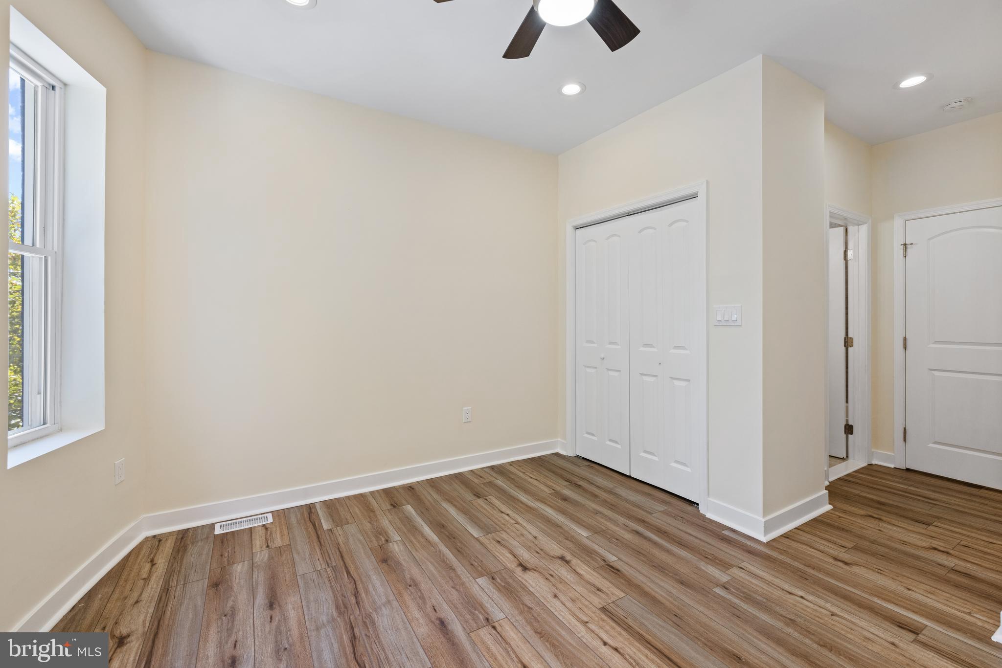 6 South Payson Street Baltimore, MD 21223 - Photo 10 of 17 wooden floor in an empty room with a window